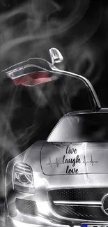 Sleek silver sports car with open door and 'live laugh love' design.