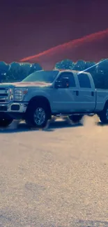 Silver truck against a dusk sky on a scenic mobile wallpaper.