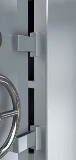 Close-up of a sleek silver vault door with metal details.