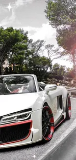 White convertible sports car on a scenic road with green trees and dramatic sky.