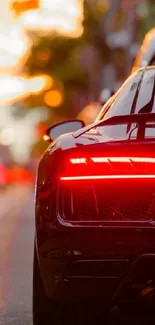 Sleek sports car on city street at sunset with urban glow.