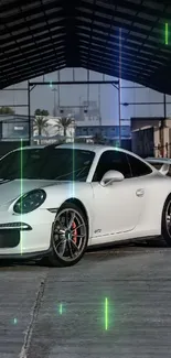 Sleek white sports car in industrial garage setting.