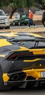 Black and yellow sports car on city street.