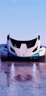 Futuristic sports car on reflective wet road under a clear blue sky.