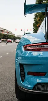 Blue sports car on urban street showcasing sleek design.