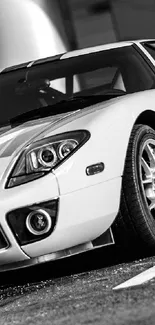 Black and white sports car parked elegantly in a spotlight.