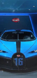 Front view of a sleek blue sports car in a dimly lit showroom.