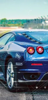 Blue sports car on track with vibrant sky.