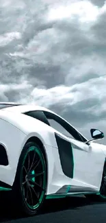 Sleek white sports car under a dramatic cloudy sky.