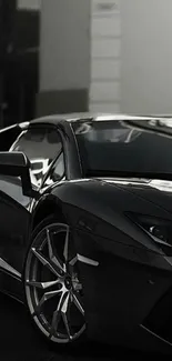 Sleek black sports car in monochrome setting.