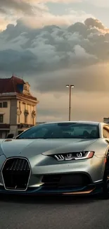 Silver sports car with sunset background.