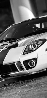 Sleek black and white sports car in a monochrome style for mobile wallpaper.