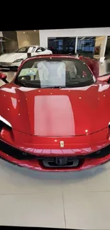 Red sports car in a modern showroom setting.