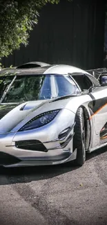 Sleek sports car parked outdoors in bright daylight.