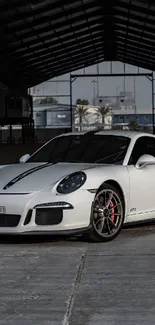 White sports car in a spacious warehouse setting.