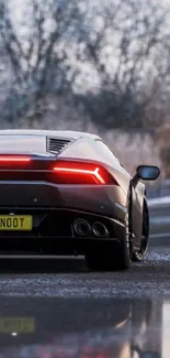 Sleek sports car on a snowy road with red taillights and a luxurious feel.