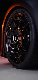 Close-up of a sports car wheel with glowing orange accent.