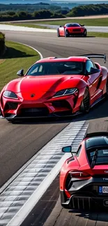 Red sports cars racing on a track, showcasing speed and elegance.