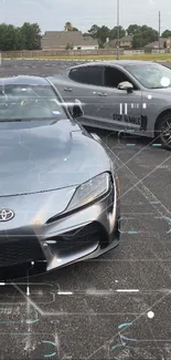 Silver sports cars in a parking lot with sleek design.