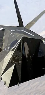 Sleek black stealth jet soaring in clear sky.