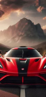 Red supercar on road at sunset with mountain backdrop.