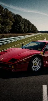 Red supercar on an open road under a clear sky.