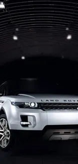 White SUV in a modern tunnel with dramatic lighting.