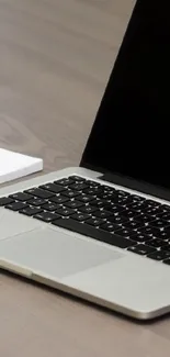 Modern tech desk setup with laptop and smartphone.