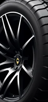 Close-up of a black tire with a sleek alloy wheel.