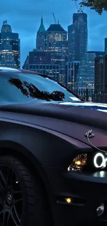 Sleek black car with cityscape backdrop under a night sky.