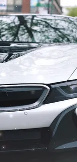 Sleek white car on a bustling city street.