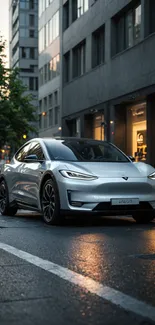 Sleek silver electric car on a wet urban street at dusk.