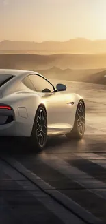 Sleek white car at sunset on a desert road wallpaper.