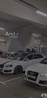 Sleek white cars in a gray garage, modern style.