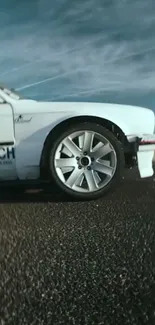 Sleek white racing car on open road, dynamic view.