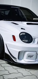 White sports car with black accents on pavement.