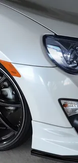 Close-up view of a sleek white sports car with elegant design features.