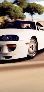 A sleek white sports car speeds along a tree-lined road.