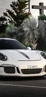 Sleek white sports car on city street, ideal for mobile wallpaper.