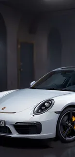 Sleek white sports car parked in a dimly lit garage.