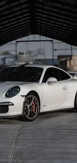 White sports car in an indoor setting with a sleek design.