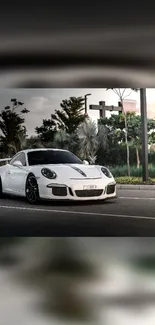 Sleek white sports car on an urban road.