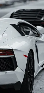 Sleek white sports car parked on street.