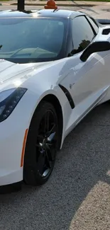 Sleek white sports car parked on street.