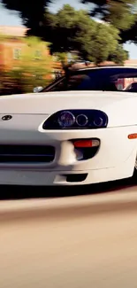 Sleek white sports car driving fast on scenic road.