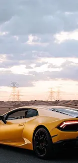 Yellow sports car on desert road at sunset.