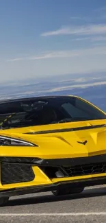 Yellow sports car under blue sky.