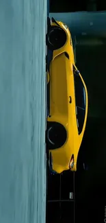 High-performance yellow sports car against dark urban backdrop.