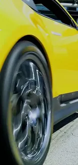 Vibrant yellow car with sleek design captured in motion.