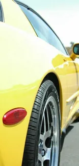 Sleek yellow sports car displayed in sunlight, perfect for mobile wallpaper.